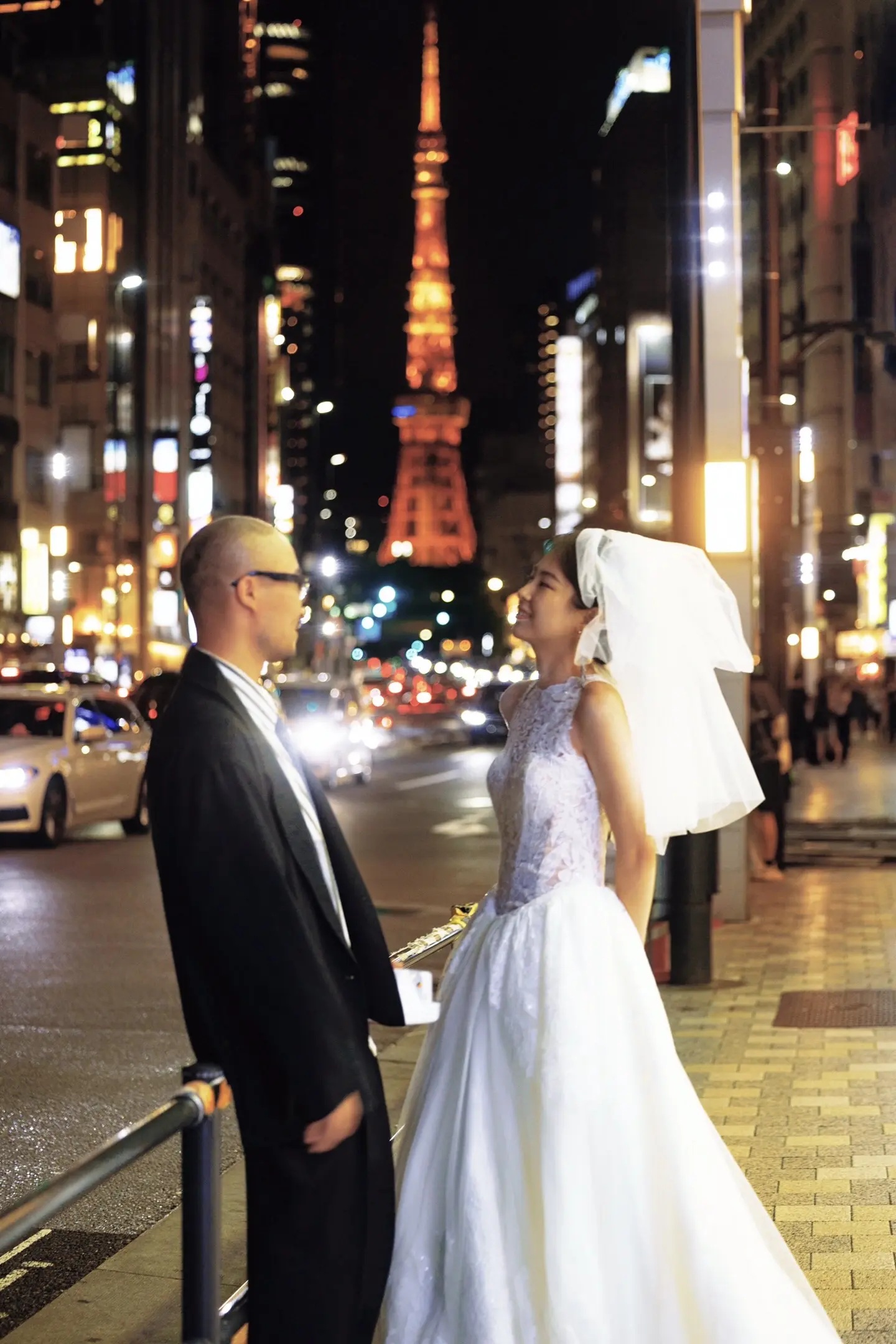 东京夜晚街头相望的恋人婚纱照