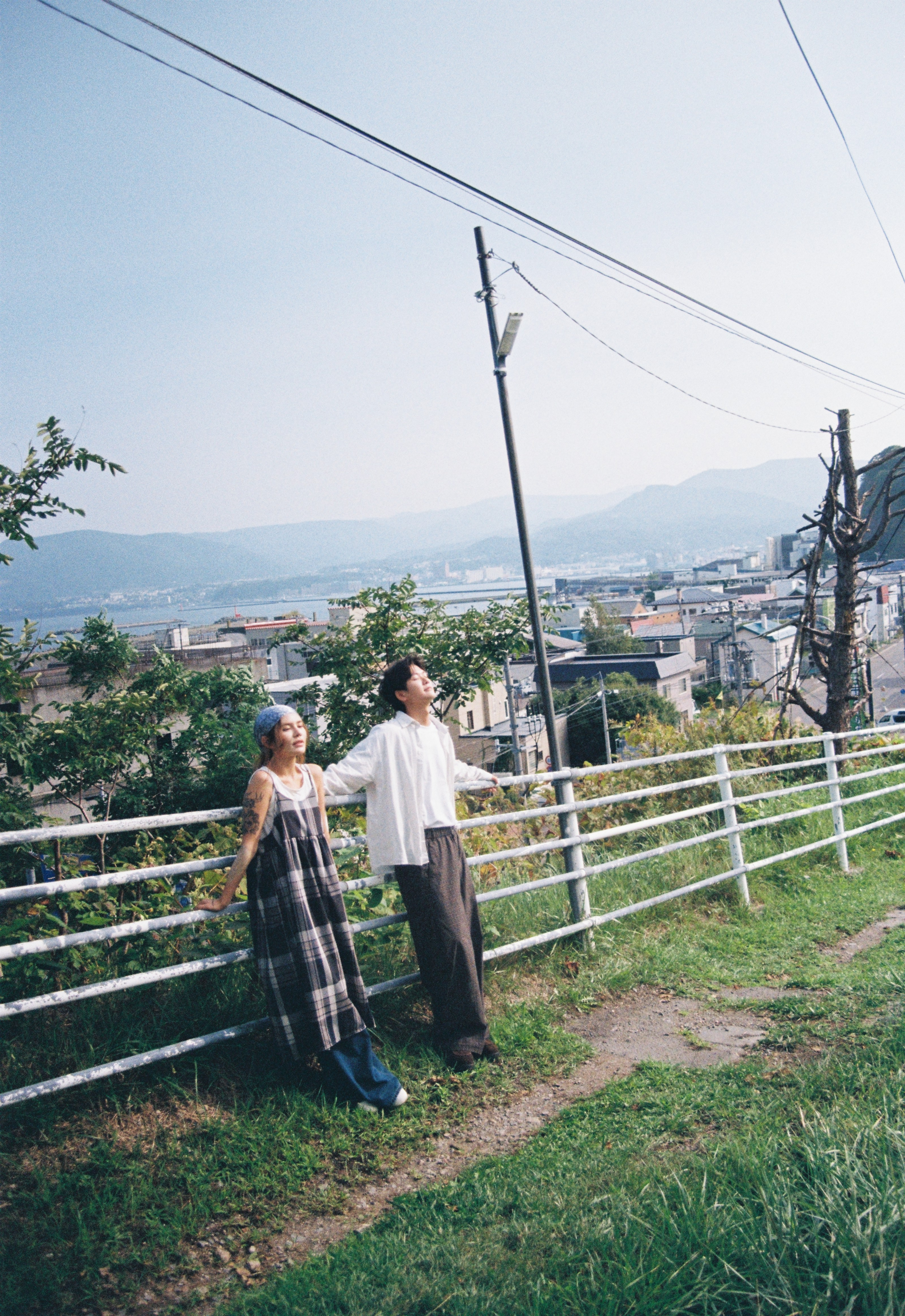 北海道山坡栅栏边的便服情侣照